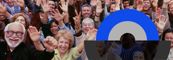 large group of older people smiling with hands raised