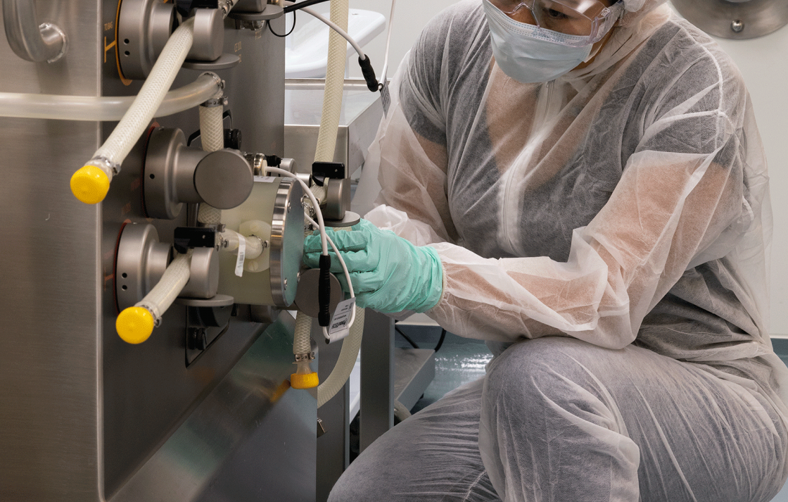 Researcher working with equipment in the Biologics Innovation Facility (BIF)