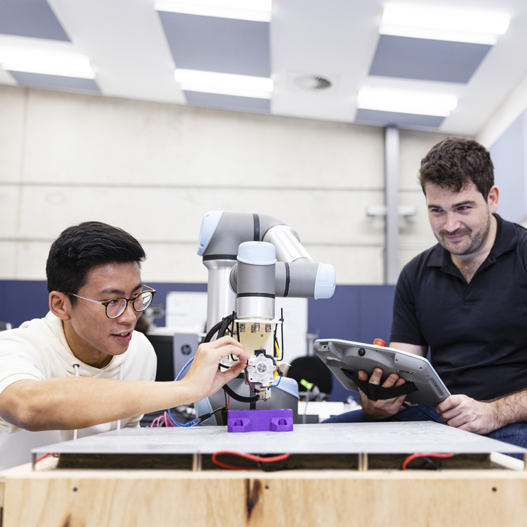 Postgraduate research student working alongside a lecturer in a laboratory.