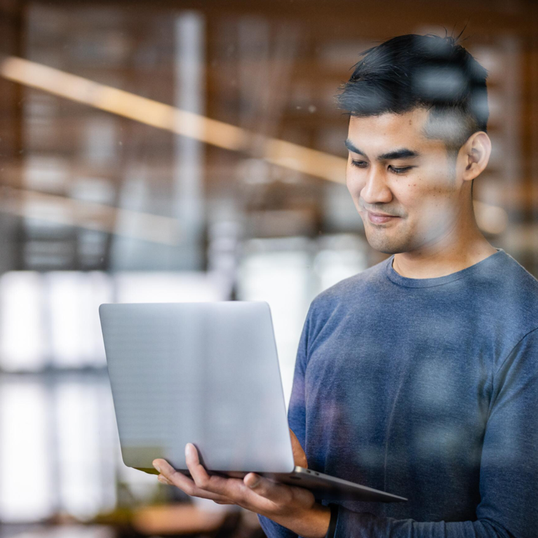 Young man looking at his laptop