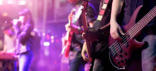 guitarists on stage. Adobe Stock