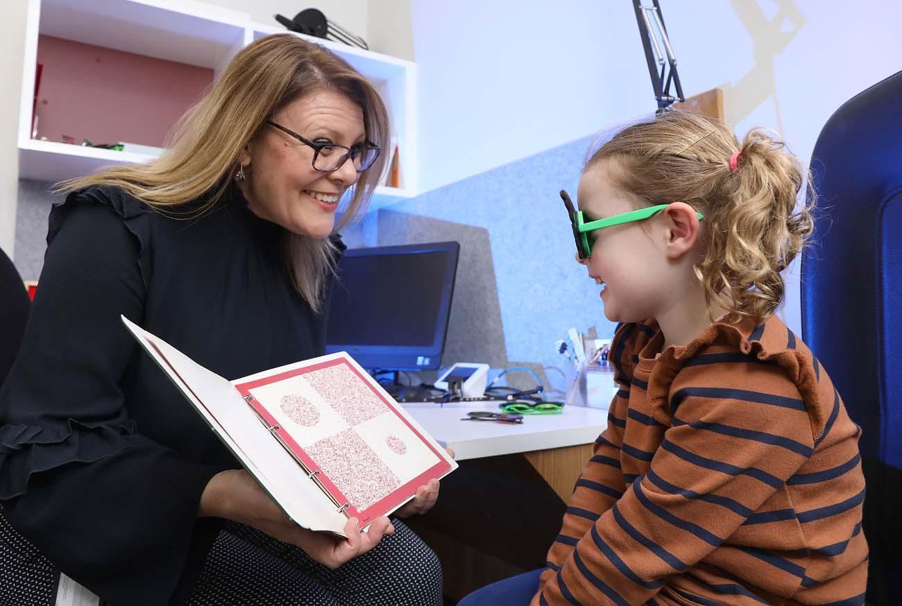 Child wearing glasses having an eye test