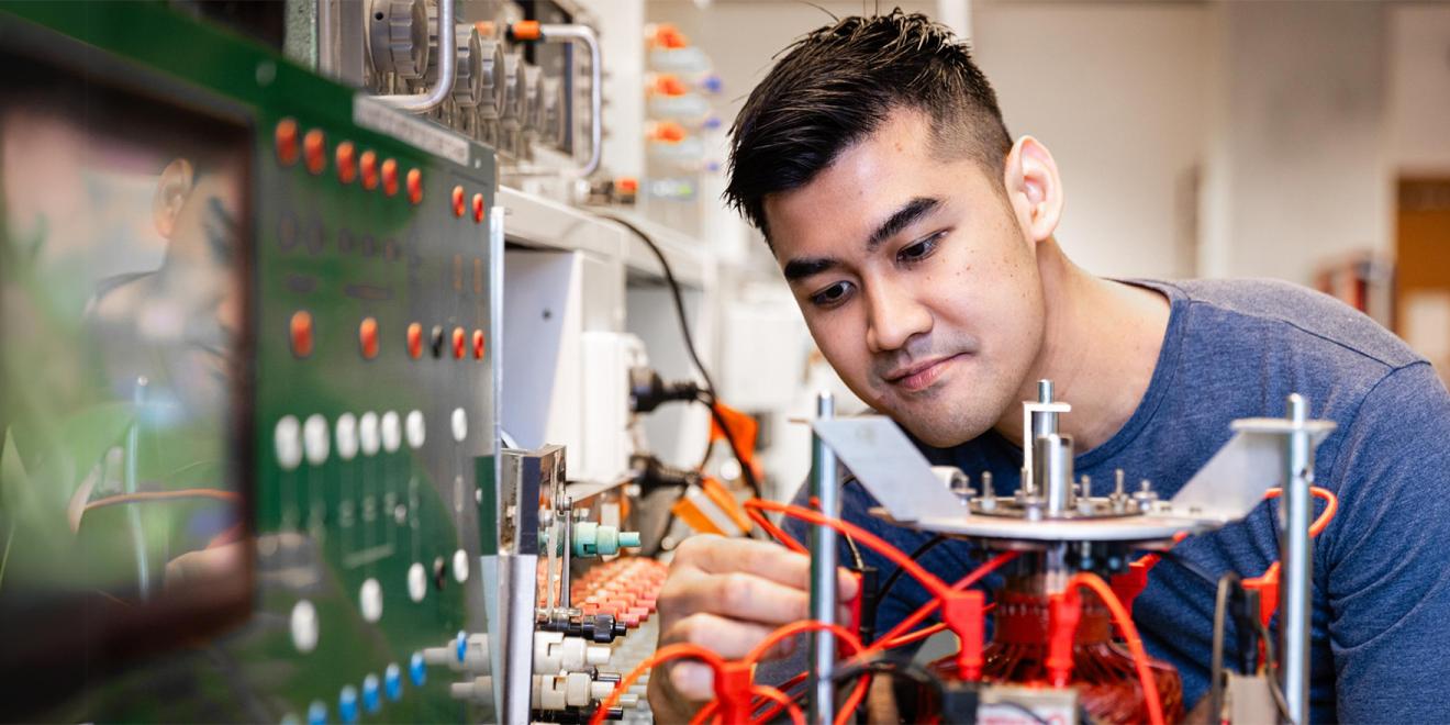 Male student studying electrical engineering