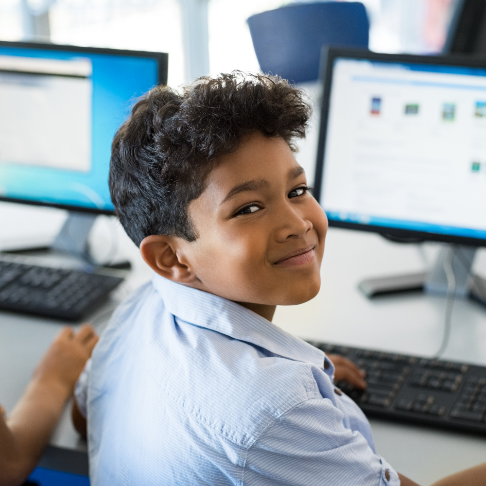 Young boy in front of computer.