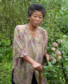 north korea woman flowers