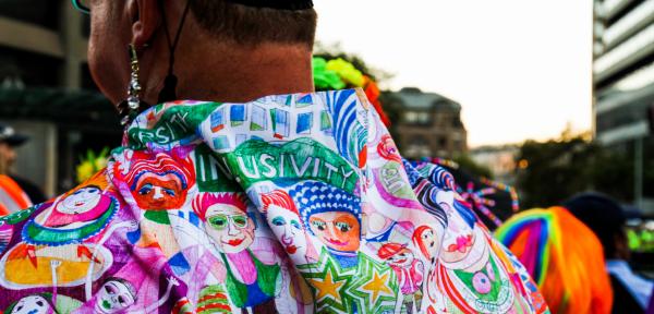 Back view of a person's shirt decorated with diversity and inclusivity images