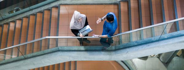 Two students standing at the staircase, at UTS DAB Building 6 