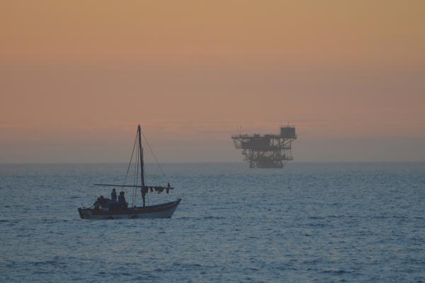 boat on ocean with brown sky