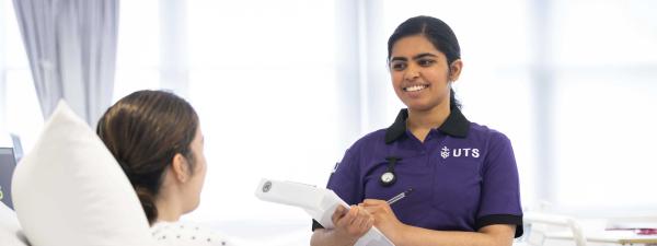 Student nurse speaking with patient