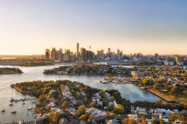 Sydney city Inner West suburbs of Balmain in view of CBD high-rise towers and barangaroo - aerial landscape in morning sun light.