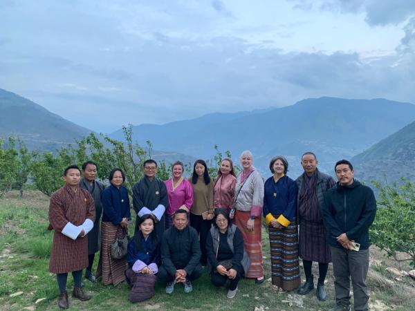 Nepalese and FASS staff stand together for a photo on a mountain