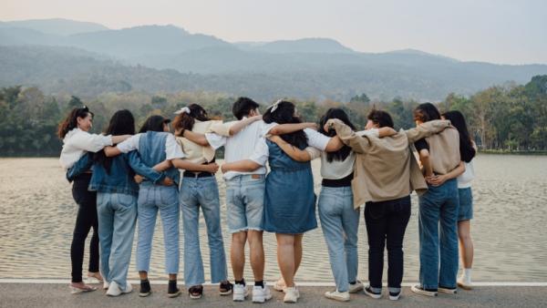 800x450 Picture from behind of group of friends embracing each other