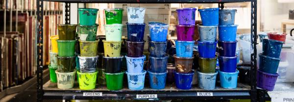 Various pots of paint on a shelf at the UTS School of Design