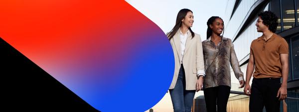 Three UTS students stand in front of a building featuring a striking red and blue colour scheme.