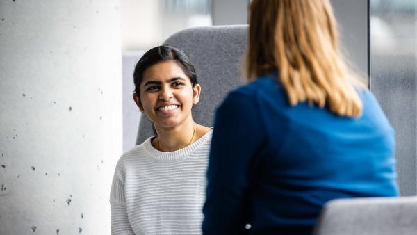 Undergraduate student smiling and chatting