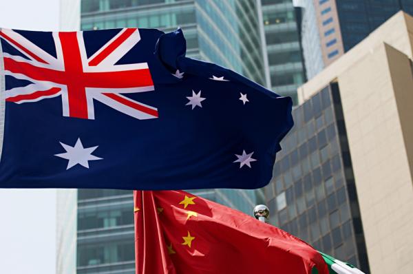 Australia flag and china waving in the wind against high building background