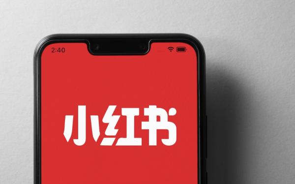 Mobile phone with logo of Chinese social media company Xiaohongshu on screen