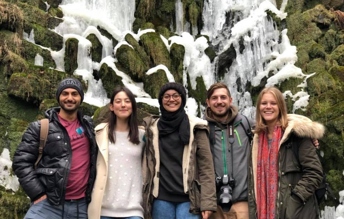 Students in front of a frozen waterfall in Germany