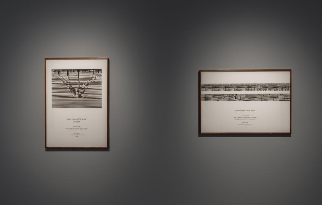 Two framed black and white photographs of footprints in the snow