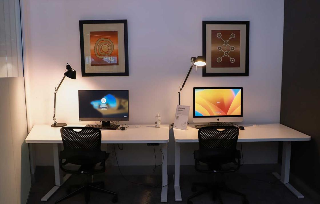 Two computers on desks