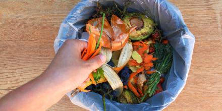 Kitchen compost bin with fruit and vegetable scraps