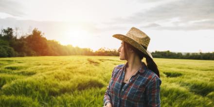 Woman farmer looking over field