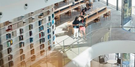 Students sharing a tablet and working together at the UTS Library