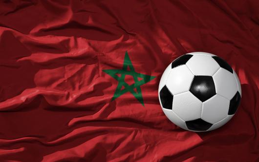 Adobe Stock picture of a soccer ball superimposed on the Moroccan flag