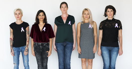 Group of people wearing purple cancer ribbon