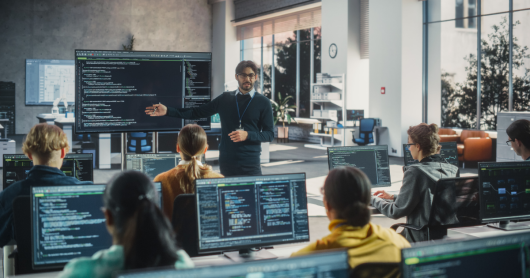 Teacher teaching coding to students