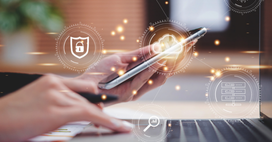 A hand holding a phone and on the foreground you can see a white graphic of security symbol, the cloud symbol and data storage symbol 