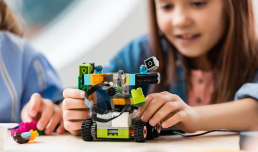 Girl playing with lego robotics