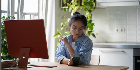 Student distracted scrolling on phone whilst studying