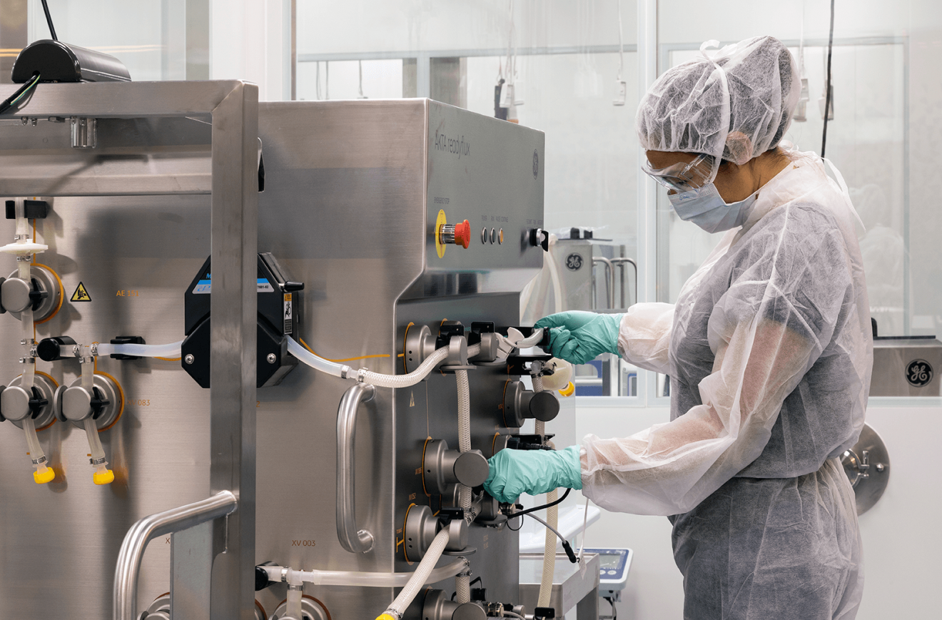 Researcher working with equipment in the Biologics Innovation Facility