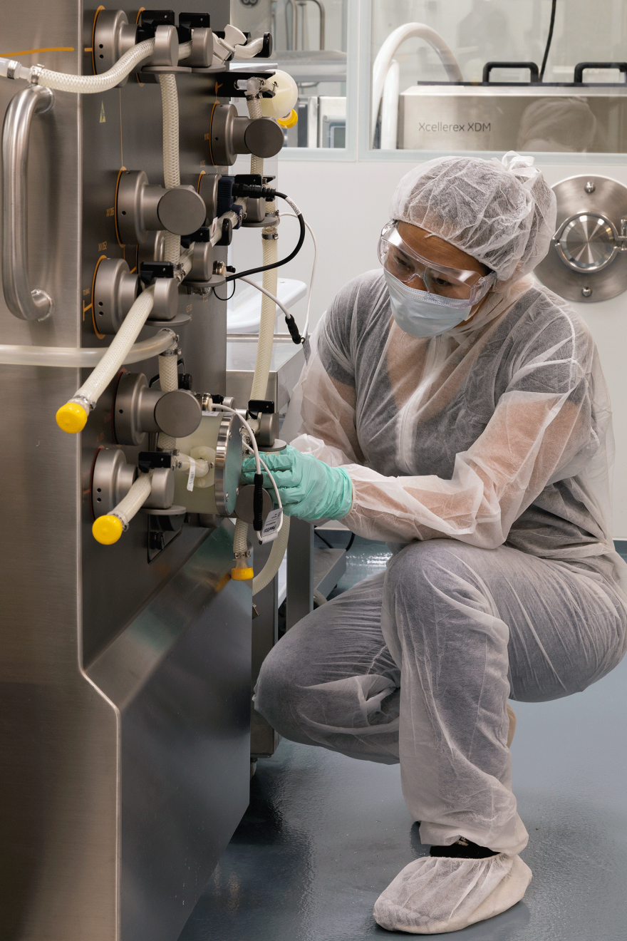 Researcher working with equipment in the Biologics Innovation Facility (BIF)