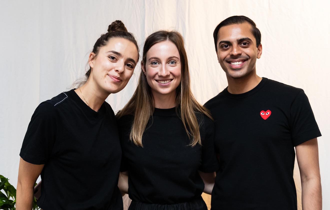 Three people in a group smiling at photographer at BCii market day 2019