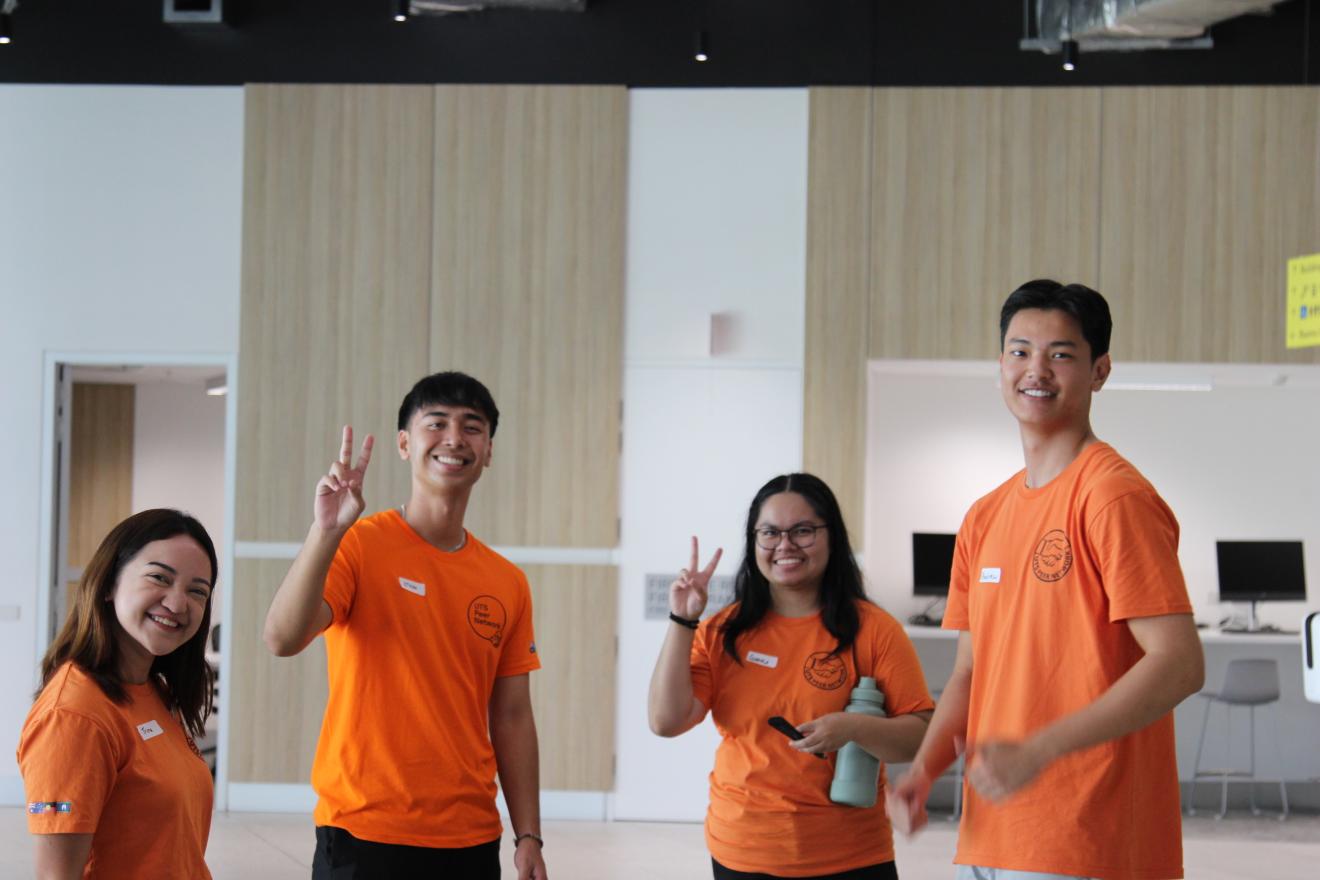 Four Peer Networkers smiling, standing in Building 2 at UTS. 