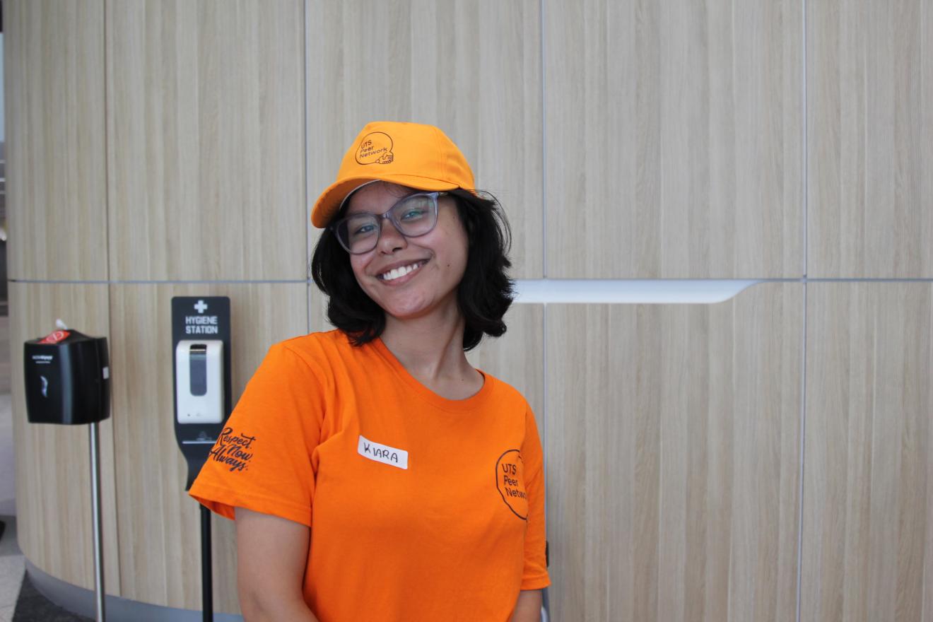 A Peer Networker smiling with merchandise