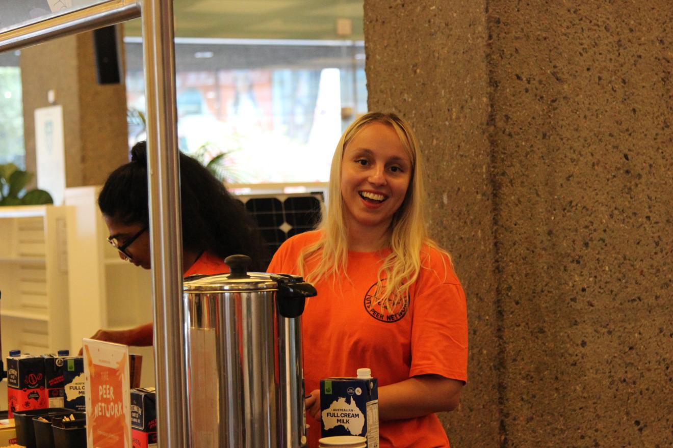 Peer Networker smiling at the Orientation cafe