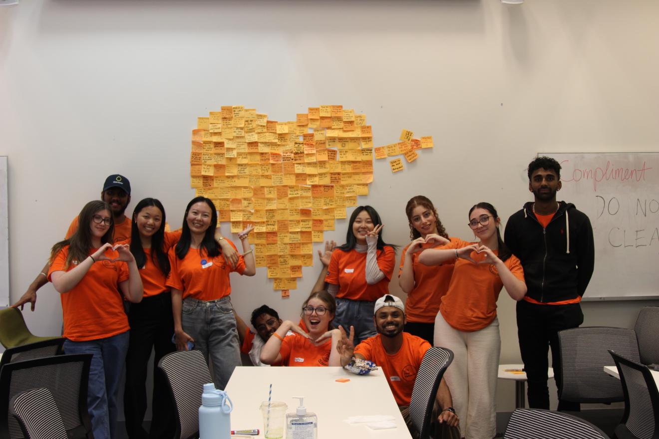 Peer Networkers posing with a heart made of sticky notes