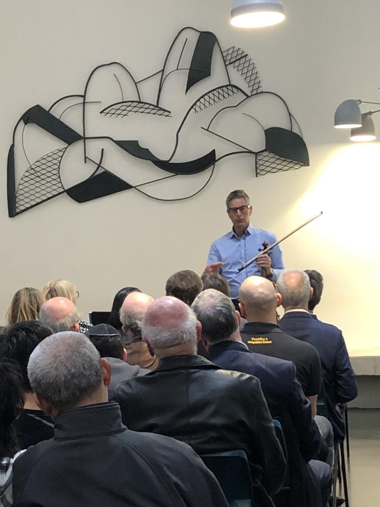 Prof Tony Dooley in the atrium of the Vicki Sara Building UTS welcoming the audience