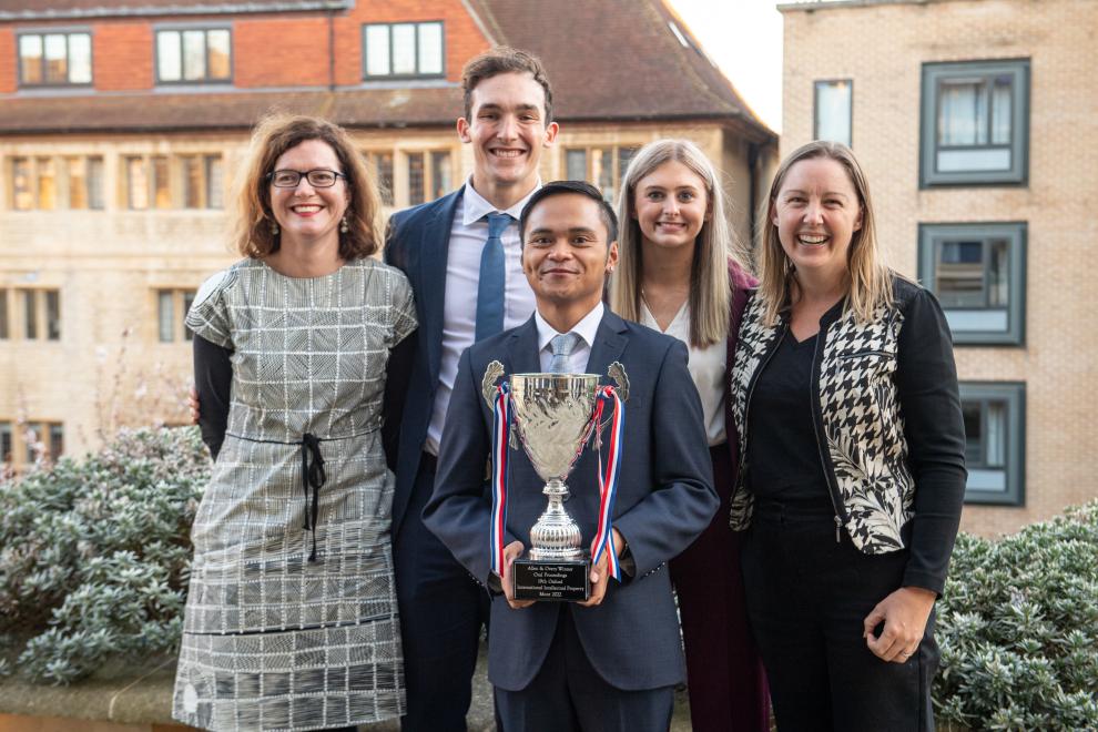 prize winners holding mooting cup