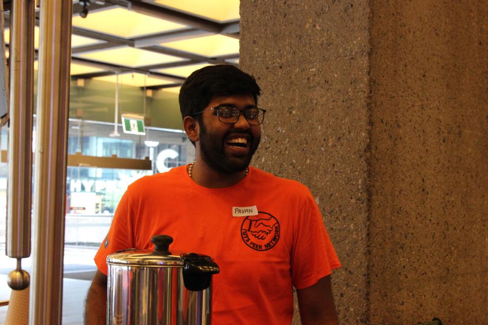 A Peer Networker laughing at the Orientation coffee cart