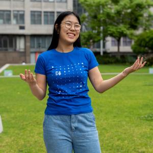 Image of student (Victoria Fu) on alumni green.