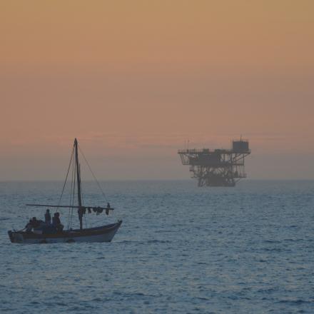 boat on ocean with brown sky