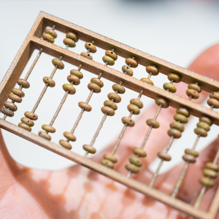 3D printed part of a small abacus being held in one hand