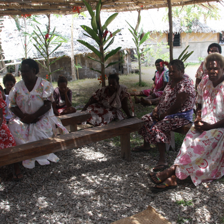 Women in Vanuatu sitting in shaded area