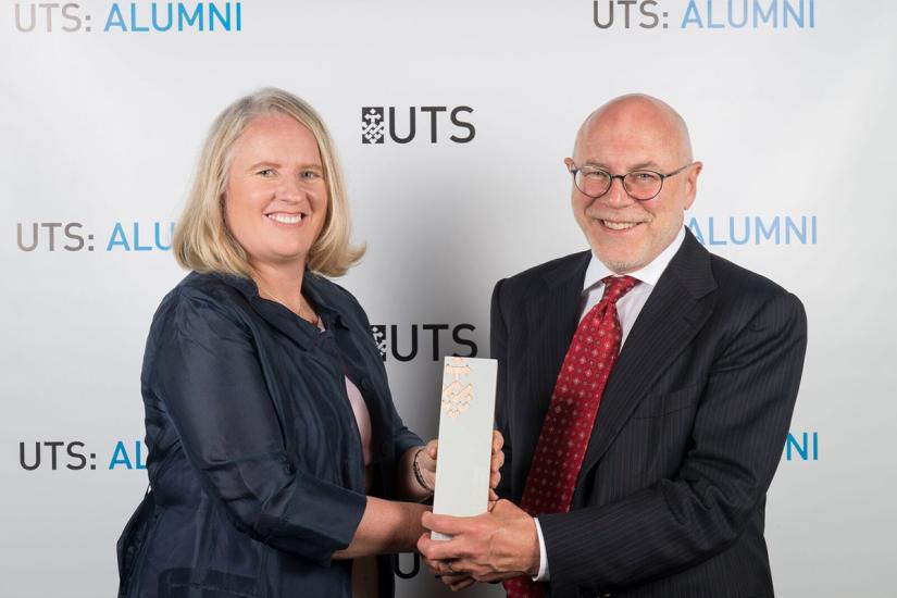 Rachel Grimes receiving her 2017 Business Alumni Award from Professor Roy Green