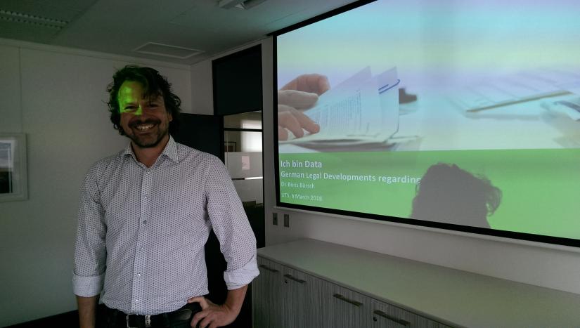 Photo of Dr Boris Boersch in front of slide presentation