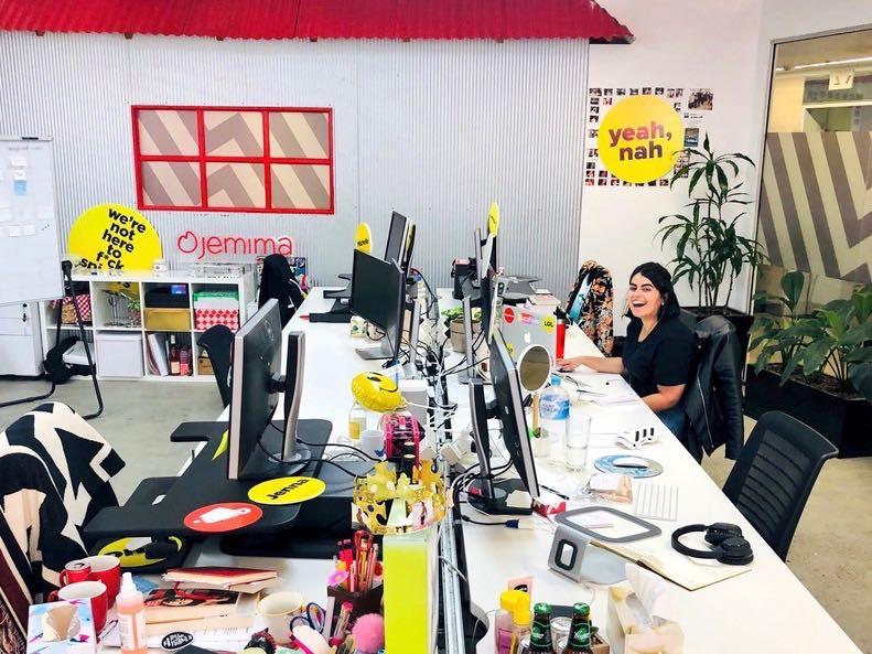 Isha sitting at her desk in the BuzzFeed office